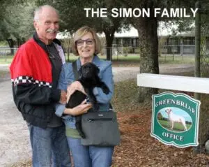 The Simon family and their new black dog